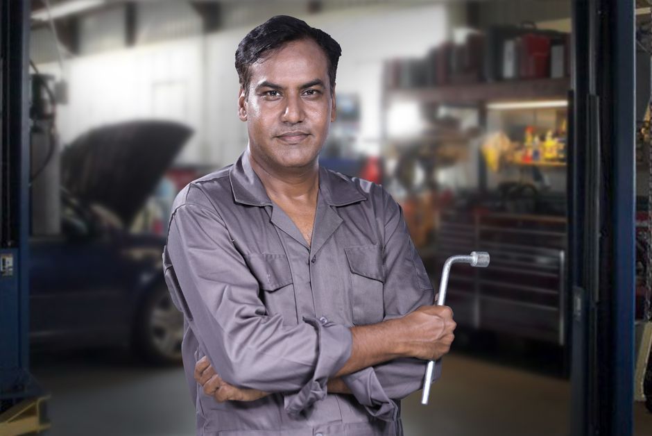 Friendly car technician ready to repair auto glass