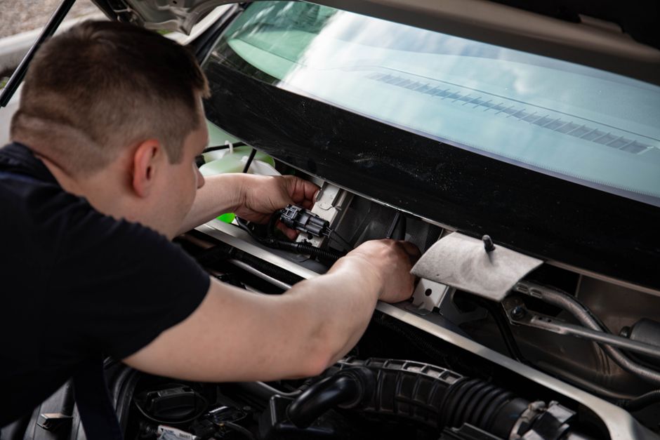 Technician repairing car window chip